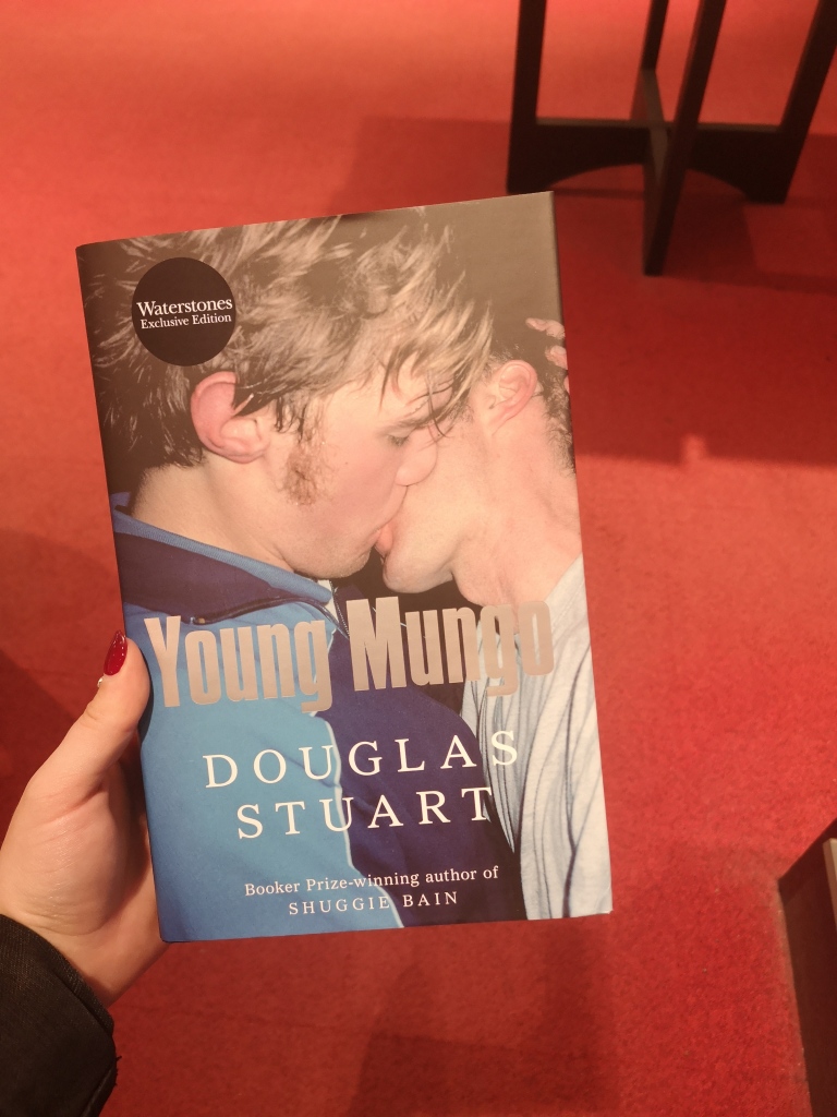 On the cover of a book are two teenage men making out, their faces mushed together. In silver text the book reads Young Mungo.